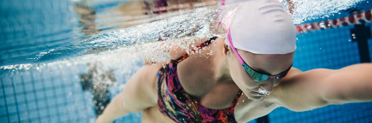 Young female swimmer swimming in pool